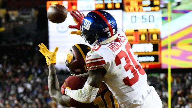 Giants cornerback Darnay Holmes tries to block a pass intended for Commanders receiver Curtis Samuel in the end zone.
